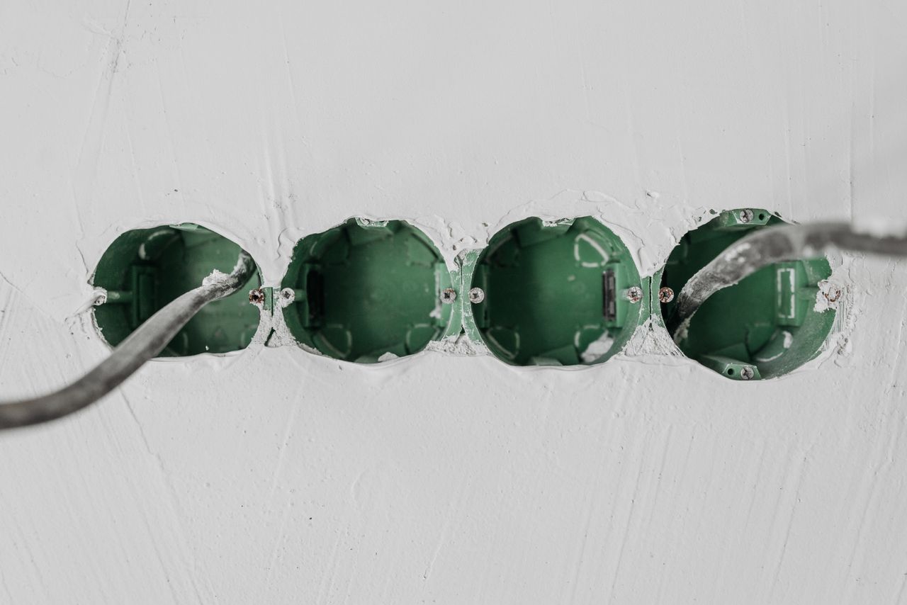 Crafting Captivating Headlines: Your awesome post title goes here Close-up of green electrical boxes and wiring in a wall setup.
